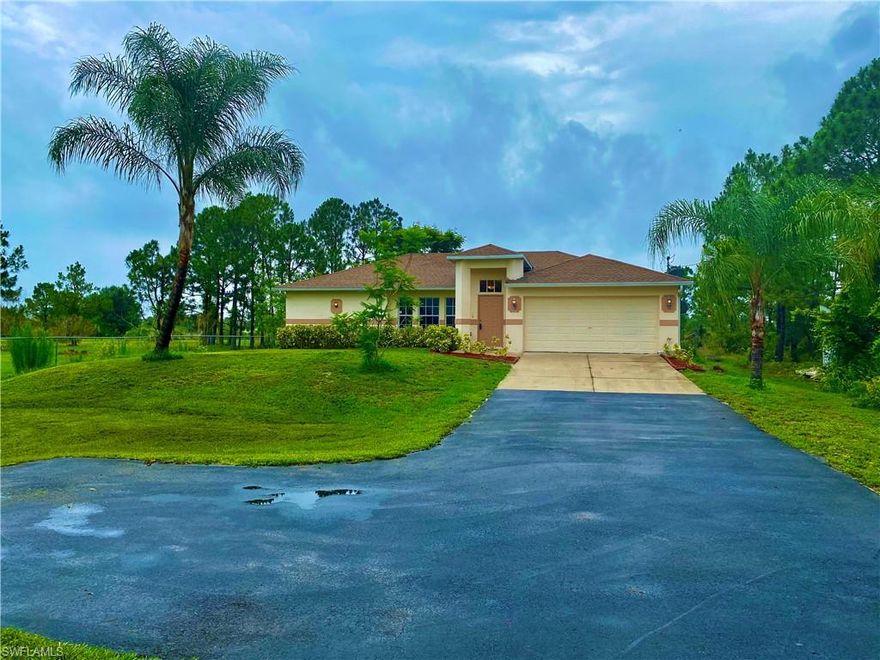 Come see this 3 BR/2BA/2CG home on 1.14 acres in the very desirable GOLDEN GATE ESTATES community. This home is located on a dead end street and sits the furthest back on the block. This updated home is gorgeous and meticulously maintained. Upon entering you are greeted with dark wood Roth & Allen laminate wood flooring, high ceilings, and a kitchen that is light and bright. The kitchen features solid hickory cabinets and marble countertops. The living area is spacious and opens to a beautiful screened in patio with your own private pond in the backyard. The master bedroom is substantial with crown molding and features a view of the back yard. The master bathroom has custom solid figured raised panel cherry wood cabinetry with a natural stone countertop. Elementary school is at the end of the street, middle and high school are only 4 miles away. Close to the new Publix, CVS, gas station and only 6 miles to the new Regional Park due to be completed 2021. This home is perfect for entertaining or family get togethers. Golden Gate Estates is a family friendly, horse friendly community with No HOA fees. One year home warranty included with the purchase.