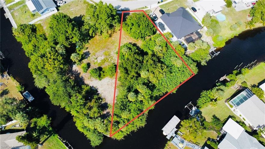 Beautiful Oversized Gulf Access Lot in the Heart of North Fort Myers! Discover the perfect spot to build your dream home on this spacious Gulf access lot, ideally located close to everything Fort Myers has to offer. Enjoy the best of Southwest Florida living with shopping, dining, downtown Fort Myers, US-41, and I-75 all just minutes away. This prime homesite sits in a no-flood zone, saving you peace of mind and money—plus, no seawall is required. You’ll appreciate the convenient location, just a short walk to North Fort Myers High School, Tropic Isles Elementary, and the North Fort Myers Community Pool. With public utilities available right on the street, this lot is ready for you to start building. Whether you’re envisioning a cozy retreat or a luxurious waterfront escape, this property offers the perfect foundation for your future Florida lifestyle. Don’t miss this rare opportunity to own a Gulf access lot close to everything—your dream home begins here!