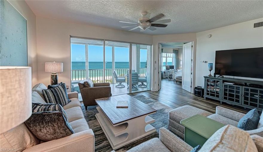 This light coastal two bedroom two bath Barefoot Beach Club in Building 267 direct beachfront condo offers it all: desirable 3rd floor location with wide & long beach views of sugar white sand & clear turquoise water of the Gulf of Mexico, beautiful sunsets from inside and on the large screened lanai, enjoy morning coffee while watching sunrises over the 100+ acre Barefoot Beach preserve land from the east facing outdoor terrace, convenient swimming pool plus new club w/fitness & 2nd pool just a short walk away, tastefully renovated including kitchen which included cabinets appliances countertops & fixtures, guest bath, flooring, crown moldings, electric shutters on the lanai, and the tasteful furnishings are included with some exclusions. Barefoot Beach is Collier County’s premier gated Beach to Bay community featuring Royal Palm lined brick paver streets, 2 security guards 24 hours, and no public parking within the community. Barefoot Beach Club is a well managed & maintained family friendly Condominium Association. Gulf access boat dock leasing options are available within Barefoot Beach. Option to join the Club at Barefoot Beach (located in the community) which offers casual & fine dining restaurants, pool & beachside food, drinks, chair service, indoor & outdoor bars, ice cream & coffee shop, tennis courts with pro & a full events calendar. (waitlist with usage during wait period). Move in ready without the hassle of a needed renovation.