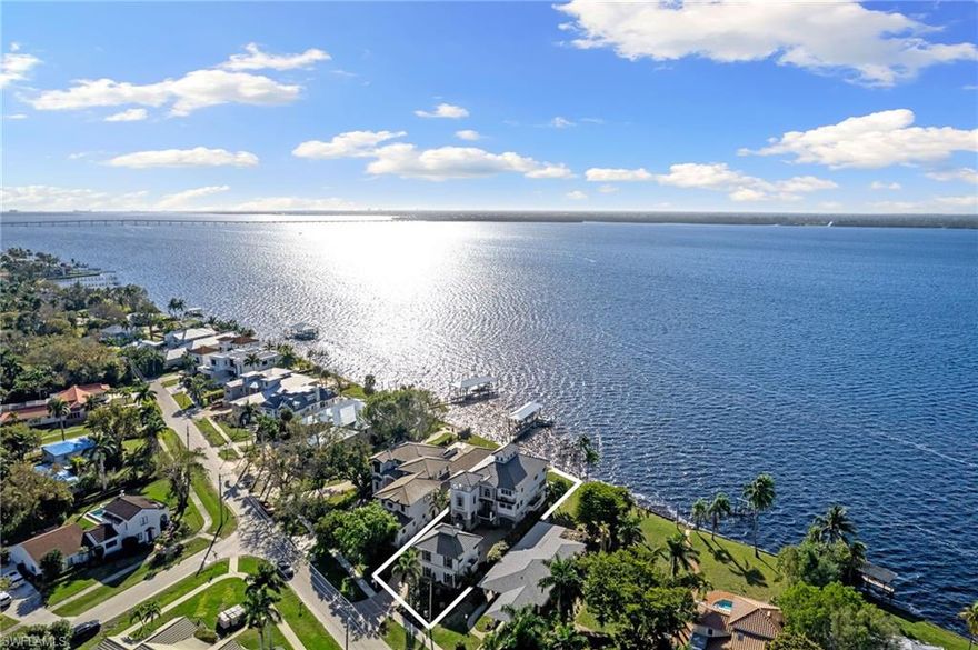 Step into a world of sophistication in this awe-inspiring riverfront estate, capturing the essence of a modern Italianate Villa nestled on the Caloosahatchee River. Immerse yourself in over 4,000 sq ft spread across 5 levels, accessible via private elevator, offering stunning panoramic water & sunset views from multiple lanais. The main house features an open great room with a fireplace, complemented by a sleek kitchen with Subzero appliances, custom cabinetry, wine refrigerator, induction cooktop, double ovens, & spacious pantries. With 4 bedrooms, 5 baths, office, and 4-car (A/C'd) garage, the main house exudes elegant comfort. The newly finished guest house, adds an additional 1,344 sq ft with the lower level hosting a professionally equipped gym. Beyond the stunning finishes, poured concrete construction, 12 in. concrete block floors & impact doors/windows reinforce the quality construction, ensuring not just aesthetic brilliance but also structural quality that stands the test of time. Brand new flat tile roofs, exterior paint & landscaping, plus newer seawall. Furnishings, décor, gym equipment are negotiable, allowing you to step into luxury & enjoy the SWFL lifestyle!