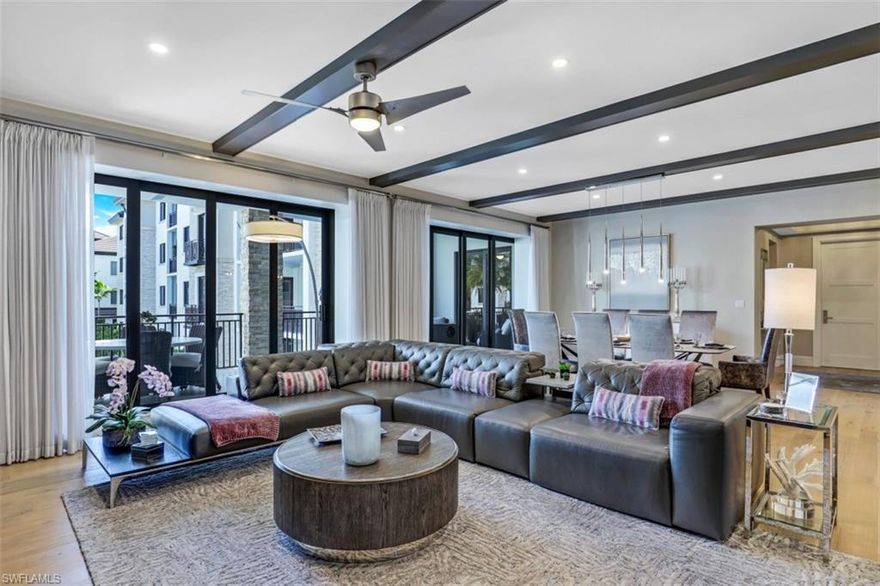 No detail was overlooked or expense spared with this professionally designed and decorated, turnkey furnished Downtown Naples residence. With almost 2,900 sqft. of luxury living space, the 3 bedroom, plus den, 3 1/2 bath home represents the best that Naples Square has to offer. Built in 2019 in compliance with stringent building codes, the home is outfitted with all impact resistant exterior doors and windows. The home includes over $1,000,000 of builder upgrades & furniture & fixtures. Upgrades include wide plank hardwood floors, custom sliding French doors, ceiling beams, a Sub-Zero refrigerator, a natural gas Wolf range, and much more. The South facing lanai overlooks the lush courtyard that includes a resort style pool, hot tub, gas grills, dining areas, and two fire pits. The home comes complete with a humidity controlled storage unit, two under-building parking spaces (one reserved), and additional bike storage. Naples Square III has a state-of-the-art fitness center, a conference room, and a Club room. Naples Square is a pet friendly community with no size limits for your 2 furry friends. Don't miss this beautiful home in the heart of Naples' vibrant Design District.