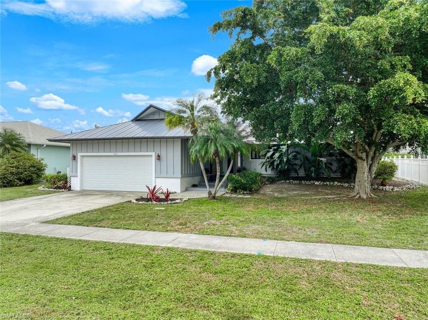 Find paradise on Marco Island with this updated 3 bedroom, 2 bath pool home centrally located close proximity to all the island has to offer. Updated with travertine flooring, wainscotting surrounds the renovated kitchen with shaker style cabinetry, stainless appliances, granite counters, neutral backsplash, island bar area and dining space. 11ft vaulted ceiling in living room with impact skylights, primary bedroom with private sliders leading out to the pool deck offers ensuite bath with tile shower and granite vanity. Spacious guest rooms with updated bathroom that features convenient pool access. Sparkling pool with large lanai and entertaining space overlooking a landscaped backyard with southeast exposure. Metal roof in 2018, a priceless upgrade with a Generac entire house generator with 500-gallon propane tank in 2022 and all newer impact sliders, windows, doors and impact rated garage door. A well maintained and move-in ready island home!
