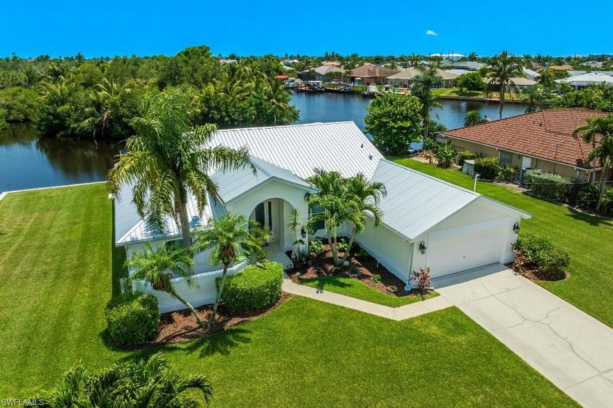 This stunning GULF ACCESS home sits on a TRIPLE CORNER WATERFRONT LOT on a cul-de-sac next to the serene Four Mile Cove Preserve, offering privacy and luxury. It features a private heated pool with a spa, an outdoor kitchen with an icemaker, fridge, sink, and a captain\'s walk-around dock with TWO BOAT LIFTS and a canopy. Key features include a new metal roof (2023), double entry lead glass doors, a large open floor plan with vaulted ceilings, new large porcelain tile plank flooring, new base moldings, and plantation shutters. The impact windows and doors, along with the updated kitchen featuring Craft Maid 42\" cabinets, stainless steel appliances, and a double convection wall oven, make this home a chef\'s dream. The master suite offers vaulted ceilings, a separate AC mini-split for personalized cooling, a walk-in closet, sliders to the lanai, and a luxurious bath with a double high-top granite vanity, a frameless tiled walk-in shower, and a private lavatory. The great room opens to the screened heated pool/spa and provides a private lanai oasis and pool bath. With its proximity to the river and open water, this home offers a perfect blend of luxury living and outdoor recreation. If you\'re seeking a premium home with exceptional features and Gulf access, this one-of-a-kind location is a must-see.