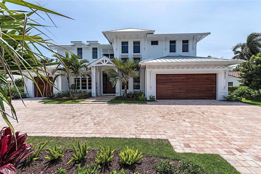 NOW COMPLETE!! Designed by MHK Architecture this new home boasts 4,267 square feet of luxury. If you enjoy outdoor living this is the home for you! Imagine sitting in your 14' spa set against a two sided fireplace that is shared with the 557 square foot outdoor entertaining area. The outdoor area includes a covered living area and kitchen with views of the pool and water feature. Large deck areas and an intimate space with trellis provide many options for your outdoor lifestyle. The home features 4 bedrooms + office, master bedroom and office are located on the ground floor, four full bathrooms, two half baths, 3 car garage, custom wine storage and an open concept plan with 2 story ceilings in the main living area. Quality appointments will be found throughout including wide plank wood floors, Anderson 400 series windows and doors, Control 4 home automation system, salt water pool, custom cabinets by Ruffino, Wolf and Sub-Zero appliances. Located a few blocks from the Moorings Private Beach Park and a short distance to 5th Avenue, 3rd Street and all that Naples has to offer. Available to be purchased FULLY FURNISHED!