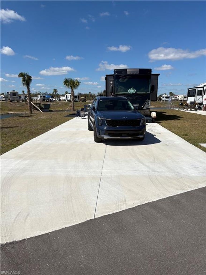 Welcome to Lot 327 at Palm Breeze RV Resort, an exceptional oversized lakefront RV lot offering water views on two sides and a beautifully landscaped setting. Ideally situated at the end of a quiet cul-de-sac, this premium lot provides added privacy and minimal traffic, enhancing the peaceful resort atmosphere.

With its expansive footprint and unique waterfront positioning, this lot captures panoramic water views while offering flexibility to design your ideal outdoor living retreat. There is ample room for a tiki hut, outdoor kitchen, expanded paver pad, fire feature, and upgraded tropical landscaping to create a true luxury RV oasis.

Enjoy tranquil waterfront living while remaining convenient to Palm Breeze’s upscale amenities, including the heated resort-style pool and spa, clubhouse with fitness center, pickleball courts, and vibrant social spaces. Located near I-75 and just minutes from Southwest Florida’s beaches, shopping, and dining.

Oversized lakefront RV lots with water on two sides and cul-de-sac privacy are rare within the community. Lot 327 presents a premium opportunity in one of Punta Gorda’s newest luxury RV resorts.