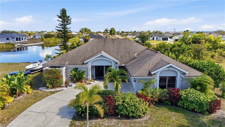Waterfront pool home in desirable NW Cape Coral with stunning intersecting canal views! This impressive residence features mature landscaping, a side-loading garage, and striking curb appeal. Enter through iron gates and double front doors to immediate views of the pool and screened lanai. The home is eastern facing, offering beautiful morning sunrises over the water.

Vaulted ceilings enhance the living room, kitchen, and family room, creating an open and airy feel. Pocket sliding glass doors from the primary bedroom, living room, and family room provide seamless indoor-outdoor living and direct access to the pool area.

The spacious split-floorplan primary suite offers privacy and includes lanai access, a walk-in closet, and an ensuite bath with soaking tub and separate shower. Two generously sized guest bedrooms share a full guest bath that also serves as the pool bath.

The large kitchen offers abundant cabinet and counter space, a pantry, plant shelf, breakfast bar seating four comfortably, and an eat-in area with a built-in bench. The adjacent family room features a wall of windows showcasing beautiful canal views.

The expansive screened lanai includes a large under-truss area—ideal for entertaining or relaxing. A front bonus room, currently used as a den, offers flexibility as a potential 4th bedroom, media room, or formal dining room.

Additional highlights include a 2-car garage with its own HVAC system, fenced yard, and concrete dock—perfect for fishing, kayaking, or canoeing. Conveniently located near shopping, dining, and medical facilities. No flooding reported, and a reasonable flood insurance quote is attached to the MLS.

Call today to schedule your private showing.