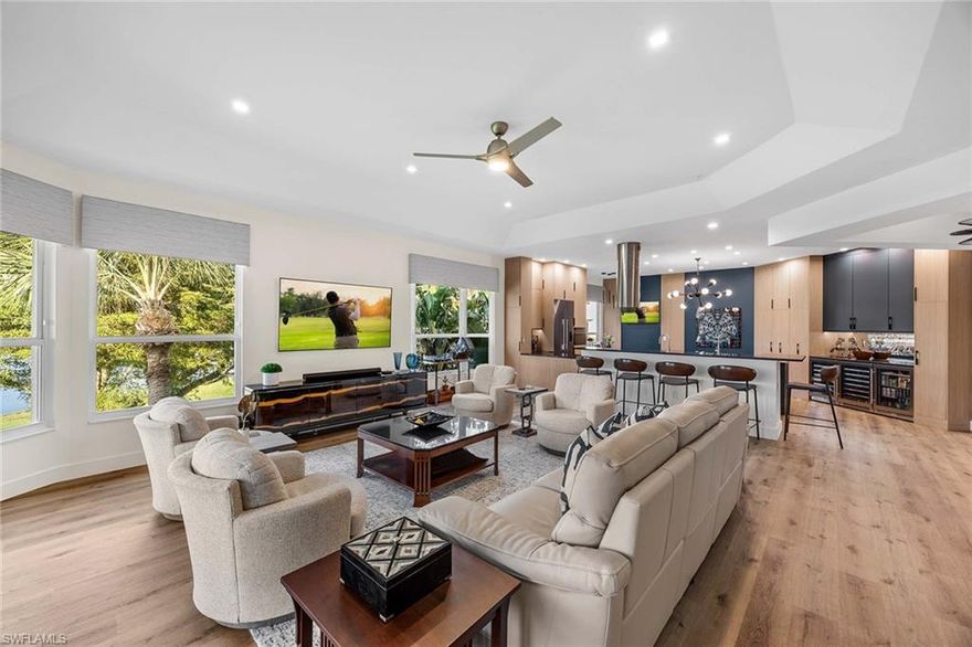 Setting a new standard for excellence, this condominium is an exceptional offering in Pelican Marsh. Meticulous and beautifully renovated, this three-bedroom, 2.5-bath residence by K2 Design Group offers exceptional style and functionality. Thoughtfully redesigned and completely renovated, the home features an open-concept floor plan with Waterford Horizon 7-inch plank flooring, designer lighting, custom valences and motorized shades throughout. The showcase kitchen includes a large quartzite island with bar seating, Lauriermax custom cabinetry, dual Blanco sinks, Franke fixtures, Fisher & Paykel stainless steel appliances, a custom double pantry and extensive storage. A custom built-in bar, complete with mirrored accents, cabinetry, and three wine/beverage coolers, enhances the home’s entertaining appeal. A beautiful breakfast nook, integrated into the kitchen, features a custom built-in seat with designer table and chairs. The kitchen opens to a spacious leisure room, creating an ideal setting for hosting a football game or holiday party! Expansive sliders from the leisure room lead to the generous lanai, showcasing long lake views and seamless indoor-outdoor enjoyment. The spacious primary suite features custom closets and a designer-appointed bath with dual quartz waterfall vanities, custom lighting, and a large shower with dual shower heads and multiple niches. Two additional guest bedrooms are spacious, one has a Murphy bed and doubles as an office. Additional upgrades include new hurricane-impact windows and Storm Smart electric screens. A rare two-car detached garage offers epoxy flooring, storage racks and extra space. Residents of Pelican Marsh enjoy access to premier amenities, including tennis and pickleball facilities, bocce courts, playground, a state-of-the-art fitness center, library and on-site dining at the Courtside Restaurant. A rare offering in prime Naples!