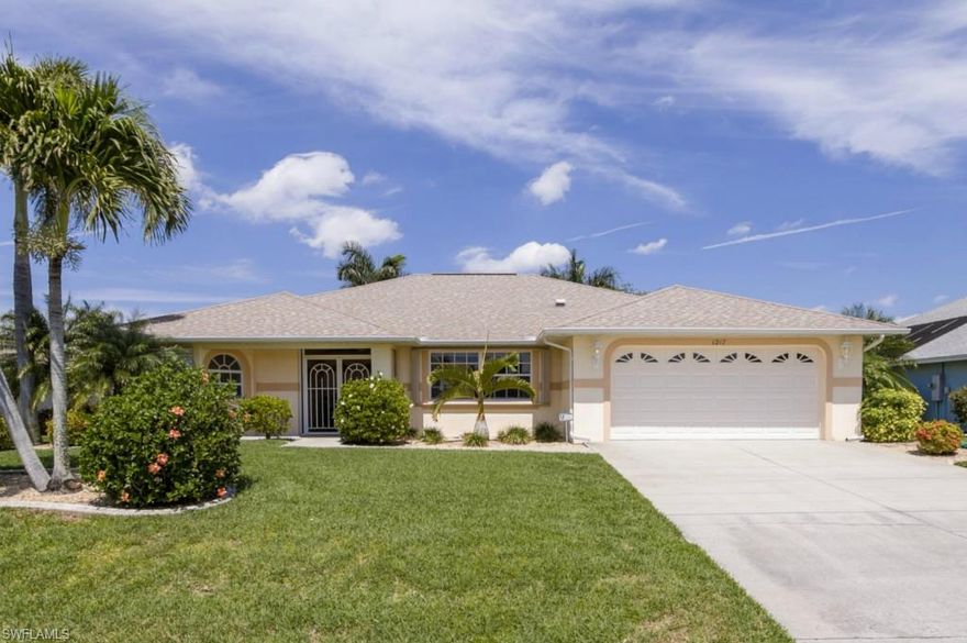 Cape Coral Gulf Access Pool Home . . . Minutes to the Caloosahatchee River . . . Assessments paid in full!  This extremely well maintained home is already set up to enjoy the boating lifestyle, featuring a proper boat dock with captains walk, boat lift, water, and electric.    Additional selling points include the following: heated pool, impressive landscaping, extra wide driveway, 18 inch porcelain tiles, new kitchen appliances in 2014, whole house water softener, reverse osmosis system, whole house surge protector, newer hot water heater, upgraded and professionally maintained A/C system + duct work, Manobloc plumbing system, security system, wood cabinets in kitchen and dining area, upgraded accordion style storm shutters, and a Smart Sense energy efficiency package with low e tinted glass and extra insulation.  This is a very well built, and very well cared for home.
