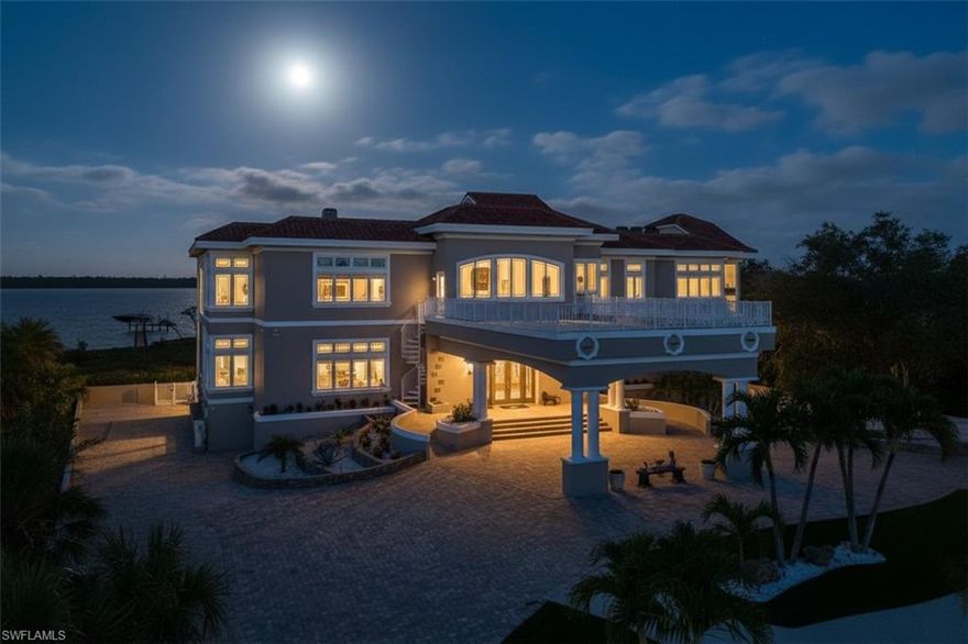 There are homes you can understand online, and then there are homes you must walk through to truly feel. This is one of them. Set on nearly 3 private acres along Lemon Bay, this gated Mediterranean-inspired estate spans 12,789 sq. ft. of resort-style living with unmatched amenities on Florida’s Gulf Coast, all within this private estate.  Enter through grand gates and follow a sweeping driveway framed by mature oaks, tranquil ponds, waterfalls, and curated sculptures. The grounds include manicured lawns, a putting green, bocce and volleyball courts, and expansive outdoor recreation.

A dramatic porte cochère introduces a soaring two-story foyer with double glass doors, stained-glass transoms, and a glass elevator. Interiors showcase coffered and tray ceilings, stately columns, marble and travertine floors, extensive millwork, and eight fireplaces.

The home offers six ensuite bedrooms, 9.5 total baths (primary bath has 3 bathroom sections but counted as 1 in the total), a library with wet bar, a media/family room with projector, fitness and meditation rooms, and rooftop terraces designed for sunset and Gulf views. The chef’s kitchen features dual islands, Sub-Zero and Wolf appliances, wine fridge, ice maker, and walk-in pantry, flowing seamlessly into both formal and casual dining areas. The primary suite includes bay views from a private screened terrace, fireplace, sitting area, spa-like bath, and custom closets, while guest suites offer private balconies, walk-in closets, and baths.

Outdoor living is highlighted by a 30×50 resurfaced saltwater pool and spa, full outdoor kitchen, shaded terraces, pool bath, and recreation courts. The property extends to a private dock with boat lift and deeded Gulf beach access. A tiled garage provides capacity for up to 30 vehicles, complete with 10 mini-split A/C systems and extensive storage, ideal for collectors or large-scale entertaining.