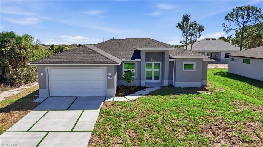 Experience elevated new construction living in Lehigh Acres with this beautifully designed 3-bedroom + den residence featuring one of the builder’s most sought-after floor plans. Thoughtfully crafted for modern Florida lifestyles, the open-concept design seamlessly connects the kitchen, dining, and spacious main living areas, creating an effortless flow for entertaining and everyday comfort. Architectural tray ceilings add sophistication throughout, while the versatile den offers the perfect space for a home office, media room, guest retreat, or flex room. The chef-inspired kitchen is complemented by stainless steel appliances, designer finishes, and clean modern lines that today’s buyers are actively searching for. The private owner’s suite serves as a luxurious retreat, complete with a walk-around shower and separate soaking tub, delivering a spa-inspired primary bath experience. Hurricane impact windows enhance storm protection and peace of mind, while the Flood Zone X location offers the added benefit of no lender-required flood insurance, a major insurance and cost advantage in Southwest Florida. Outdoor living shines with a covered lanai and outdoor kitchen, perfect for year-round entertaining, weekend cookouts, and enjoying the Florida lifestyle. Additional highlights include a dedicated laundry room, spacious 2-car garage, and quality craftsmanship throughout. Ideally situated in a convenient Lehigh Acres location near SR-82, Fort Myers, shopping, dining, and Southwest Florida beaches, this move-in-ready home blends modern luxury, lifestyle convenience, and long-term value.