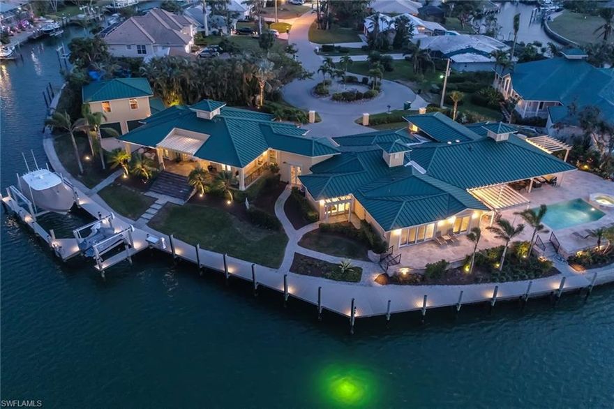 Nothing like this in Southwest Florida! This Custom Estate Home was built on double lots with 342' on water direct. Bring the 80' yacht, 42' boat and jet skis as this estate can handle it all! Completely remodeled in 2004 for main house, new attached  guest house addition and detached two-car garage with game room/ loft ( 2004)! This home features four bedrooms and seven full baths plus den ( loft could be used for 5th bedroom with attached bath)- room for the whole family! Massive lanai with travertine decking, and PVC dock surrounding Estate. Sitting on a protective bay, this home is two seconds to the Gulf! NEW upgrades to the home include complete in-house generator, Newer seawall on lot 9,(2014),seawall on lot 10 was built in 2004, newer roof on all buildings with 35 year guarantee(2013), newer A/C units and air handlers,( 2013 and 2017) Newer PVC Yacht deck (2014),Newer landscaping, painted exterior and interior. New kitchen in 2017, new 50lb lift on boat slip.( 2017) Bring all the toys as this is a true boaters delight!