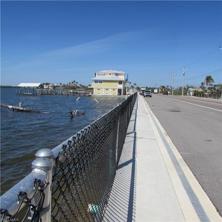 Two Sided Bay frontage corner with direct view of The Matlacha Swing Bridge "The Fishingest Bridge in Florida".. This is a unique opportunity to purchase  the DOUBLE LOT located at the SE corner of the Matlacha Bridge.... Permits are being prepared for seawall, fill and the ability to build your bay-front property. Call Real Estate Agent for updated information !! This property used to be the BRIDGEWATER MOTEL and SHOPS... Get it before these turn into $multi Million Dollar$ properties !!! The Zoning is C-1 but is in the Historic District where many properties are residential, Multi or Commercial... Where else can you find Two Sided Bay frontage at this price !!!! Cape Coral and the 7-islands on one side...Pine Island (the largest Island in Florida) on the other side !! The Future is yours... Call Today...