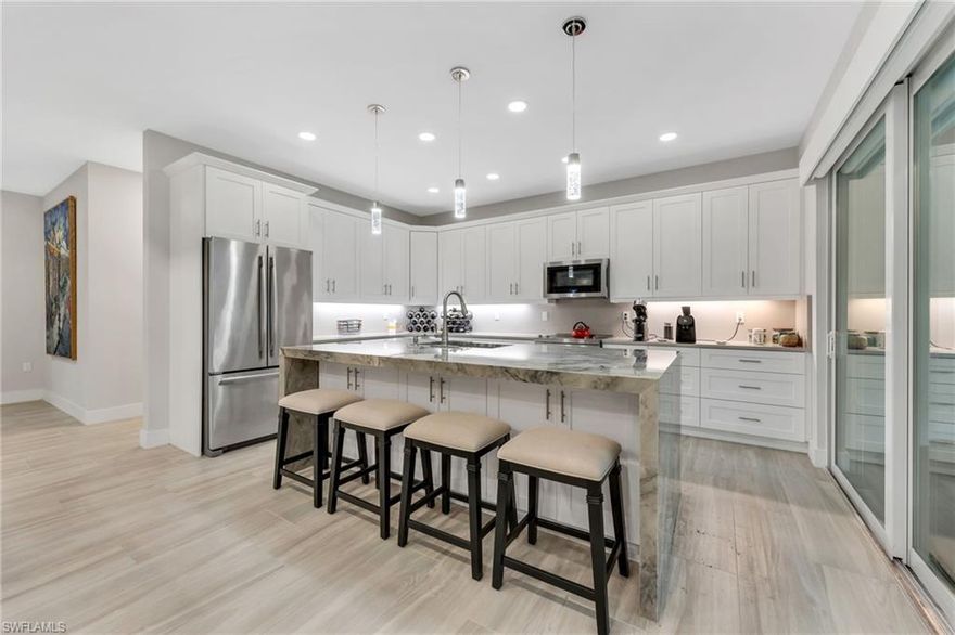 Exquisite One-of-a-Kind Custom, move-in ready home. This stunning 3-bedroom plus den, 2-bath residence has been meticulously customized from top to bottom and sits on 2.5 lush, secluded acres, offering the perfect blend of luxury, privacy, and serenity. The heart of the home is a breathtaking gourmet kitchen featuring a dramatic onyx island with waterfall edges, complemented by sparkling quartz countertops and a matching quartz backsplash. Beautiful custom barn doors glide open to reveal a private office or den, while the luxurious primary suite boasts a spacious walk-in closet and a spa-like bathroom. All windows are tastefully decorated with wood plantation shutters. Your new favorite retreat awaits on the expansive 300-square-foot covered back porch, surrounded by complete privacy and the soothing sounds of nature—perfect for morning coffee or evening relaxation. The driveway and yard are adorned with floratam grass and several fruit trees, such as avocado, grapefruit, fig, lemon, lime, orange, and peach. Enjoy crystal-clear water throughout the entire home thanks to a whole-house reverse osmosis filtration system.  Every window and door is storm impact rated, providing ultimate safety and peace of mind.  Every detail has been thoughtfully designed and upgraded, making this rare gem truly one of a kind.