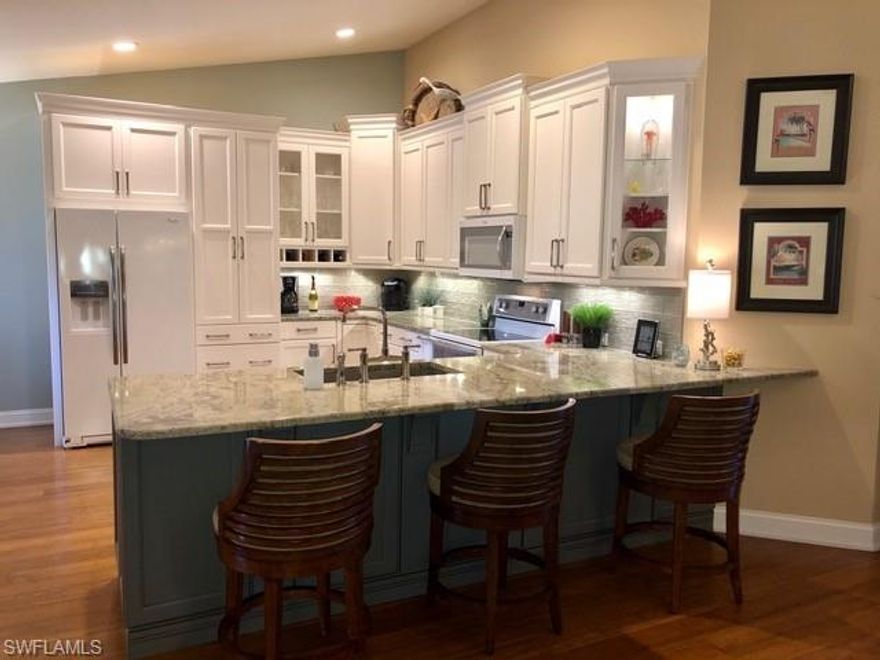 Wow totally remodeled Coach home with a spectacular view of the large lake, lined Palm trees and golf course. This truly one of a kind home offering 2 bedrooms, den with glass French doors and 2 totally remodeled bathrooms. Starting from the recently installed gorgeous bamboo flooring, to then be wowed by the totally remodeled kitchen with all the extras that you could possibly imagine. Looking for an active lifestyle community look no further. Spring Run offers bundled golf, bocce, tennis and optional membership to the Brooks commons club and exclusive Beach Club.