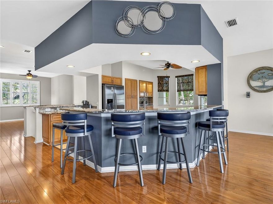 Enjoy easy, elevated living in this beautifully maintained second-floor, end-unit condo tucked inside the established, gated community of Spanish Wells in the heart of Bonita Springs. Perfectly positioned just 3 miles to the beach and 3 miles to I-75, the location offers both convenience and a relaxed coastal lifestyle. This light-filled residence features 2 bedrooms plus a spacious den, 2 full baths, and a 1-car attached garage. From the moment you arrive, you’ll notice thoughtful touches like the glass front door with sidelight and a modern, airy foyer fixture that set a whimsical tone. Inside, the open-concept floor plan lives comfortably, with a generous living and dining area that flows seamlessly into the kitchen and large breakfast bar—ideal for both everyday living and entertaining. The remodeled kitchen is timeless and beautifully done, showcasing rich wood cabinetry, granite countertops, a tile backsplash, stainless steel appliances, and abundant storage and prep space. The den is perfectly integrated into the main living area, offering flexibility for a home office, reading nook, or additional guest space. It can even be enclosed for an extra bedroom or privacy. One of the standout features is the completely redesigned guest bath—an upscale, designer-inspired space blending wood, tile, and glass for a sophisticated, spa-like feel. Throughout the home, you’ll find glossy laminate flooring and plantation shutters that add both style and continuity. The split-bedroom floor plan provides privacy, with a spacious primary suite set apart from the guest bedroom. The suite offers a large bath and an oversized walk-in closet. The primary bath remains in its original condition, presenting a wonderful opportunity to customize and bring your own vision to life. Step out onto the spacious lanai and enjoy peaceful views overlooking the pool—perfect for morning coffee or unwinding at the end of the day. Spanish Wells is known for its mature landscaping, walkable streets, and active lifestyle. Optional membership provides access to a championship golf course, tennis, fitness center, dining, and a full calendar of social activities—entirely your choice, not required. Outside the gates, you’re surrounded by abundant shopping, dining, and everyday conveniences, with even more options just a short drive away. Southwest Florida International Airport is approximately 30 minutes from your door.  A wonderful opportunity to enjoy comfort, flexibility, and the best of Southwest Florida living!