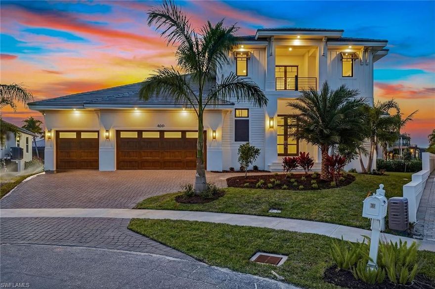 Experience refined living in this exceptional new construction estate, just completed January 2026 by award-winning Stonebreaker Builders. Where architectural brilliance and timeless craftsmanship converge. Set on a rare tip lot offering 176 feet of waterfront, this residence captures mesmerizing western sunset views over expansive converging waterways, with vistas stretching across Collier Bay toward the Gulf. This is a rare opportunity to own a custom Stonebreaker home in one of the island’s desirable neighborhoods, offering proximity to Snook Inn, Old Marco entertainment district, the Esplanade and Residents’ Beach. Designed for luxury and livability, the impressive 3,896-square-foot two-story estate offers 176 feet of waterfront and quick direct Gulf access, an exceptional advantage for boating enthusiasts. This five-bedroom residence features five full en-suite baths, two half baths, a flex room and a three-car garage, all executed with Stonebreaker’s signature attention to detail. The exterior showcases a flat tile roof, impact doors and windows, and an elevated homesite over 11 feet. A grand foyer with a soaring two-story ceiling immediately sets an elegant tone. The open-concept great room, kitchen and dining area feature 12-foot ceilings and expansive glass accordion doors that frame shimmering pool and bay views, creating effortless indoor-outdoor living. The great room centers around a striking 60-inch gas fireplace with a tray ceiling, while the chef’s kitchen impresses with a beamed ceiling, gas cooktop, large center island and walk-in pantry. The outdoor living area is ideal for luxurious waterfront entertaining, offering a covered lanai with an outdoor kitchen, built-in gas grill, outdoor shower, a dedicated pool half bath, and a 30-foot pool with spa and sun shelf. The main-floor owner’s suite offers serene retreat with lanai access, two walk-in closets and a spa-inspired bath with dual vanities, a built-in makeup counter, linen closet, dual walk-in shower with multiple shower heads and a deep soaking tub. A secondary owner’s suite on the first floor also offers lanai access, a walk-in closet and en-suite bath. Upstairs, a spacious flex room creates an ideal lounge space and opens to a remarkable 65-foot covered balcony overlooking Collier Bay and the Gulf. Three additional second-floor bedrooms each feature private en-suite baths. Additional highlights include a mudroom off the garage and a tankless water heater. Just completed, embrace sophisticated waterfront living in this unparalleled Marco Island residence, crafted with exceptional quality.
