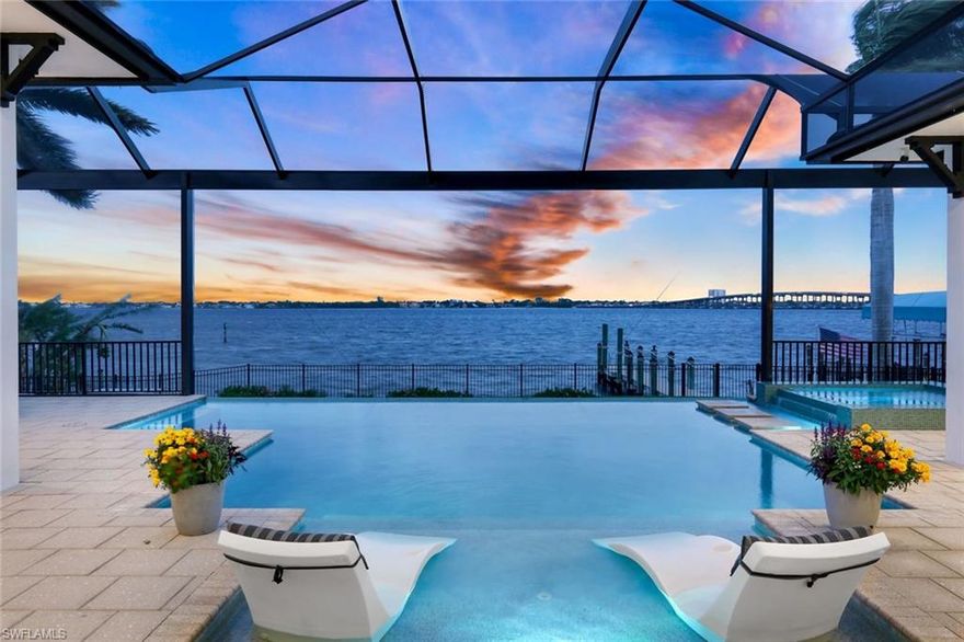 A rare collaboration between Windward Construction and a professional designer, this custom Makani Model is one of the most extraordinary riverfront homes and is impossible to replicate at today's costs. Set on a 1/3 lot, this 2020 residence offers panoramic water views, instant Gulf access, and an elevated level of finish that goes far beyond Windward's already exceptional standards. With 3 beds, a private office, 3.5 baths, and a 3-car garage with a mini-split, every inch of this home was intentional. Step through the 12-foot Acadian iron-front door and into a dramatic, light-filled interior defined by soaring vaulted & coffered ceilings and a wall of glass that frames the river like a living painting. The designer kitchen is the heart of the home, anchored by a seamless 118x66" island and wrapped in Montoro Premium Dolomite, one of the most sought-after natural stones in luxury design. The Dolomite carries throughout, bookmatched and perfectly mirrored across the back countertop surfaces, creating a dramatic, gallery-quality effect where the natural veining flows as one continuous, uninterrupted statement. Dacor Modernist appliances include a paired 30" fridge & 30" freezer, beverage and wine refrigeration, and a walk-in pantry outfitted by California Closets. Every detail is bespoke. Living room opens fully to the outdoors, effortlessly blurring the line between inside & out. Designer lighting, refined materials, and a warm, welcoming atmosphere make this home livable & stunning. The Owner's Suite overlooks uninterrupted water views for miles. The spa-inspired primary bath features a Marvel Slate Listello herringbone accent wall paired with a tumbled Carrara white herringbone mosaic floor. Guest bedrooms are positioned in a private wing, ideal for extended stays. Outside, your private waterfront oasis is resort-grade in every respect. The saltwater pool and spa feature Cancun Blue PebbleTec with Abalone shell, a glass-tiled sun shelf, LED nicheless lighting, and a gas heater. A 30-foot picture window screen preserves completely unobstructed panoramic river views. The 2024 outdoor kitchen is fully equipped for serious entertaining, finished in Black Absolute Leather granite with a 32-inch professional grill and refrigerator. The SE exposure is exceptional — breathtaking sunrises, southern sun over the pool all day, and sweeping evening views of the city skyline. This home was made for 4th of July and New Year's gatherings. Boating access is instant, no canals, no slow-speed zones, direct to beaches, islands, waterfront dining, world-class fishing, and the Gulf. Additional upgrades include whole-home climate control with five Wi-Fi-enabled thermostats for individually zoned control, full smart home integration, linear AC vents, spray-foam insulation, and an extended garage depth. Windward Construction is a multi-year, award-winning builder. 2026 Showcase of Homes Windward earned 16 awards, with many top honors. Full upgrade list upon request.