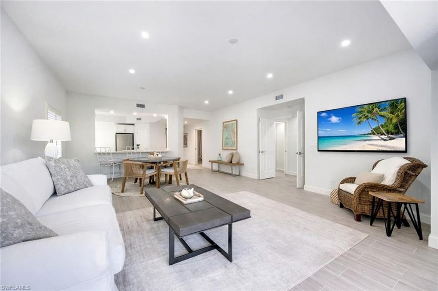 FULLY RENOVATED! Located on a coveted, beautifully landscaped unit with the convenience of first-floor living, this updated residence offers exceptional privacy, peaceful surroundings, and an inviting lifestyle. Enjoy tranquil views of the clubhouse pool from your expansive screened lanai. The open and functional floor plan features three bedrooms, including a versatile third room that can serve as a bedroom, den, or home office, along with a spacious living area ideal for both everyday living and entertaining. The interior showcases white-washed oak tile flooring throughout and is enhanced by coastal décor and furnishings that may be included for a truly turnkey opportunity. The open kitchen features quartz countertops with subtle shimmering flakes, a center island, new stainless steel appliances, and seamless flow into the main living areas. Additional upgrades include a new A/C system, new water heater, new washer and dryer, updated lighting throughout, and a fully refreshed lanai with new tile flooring. The charming courtyard entry is framed by lush garden landscaping, creating an inviting arrival. The primary suite features a fully reimagined spa-style bath with raised ceiling, custom cabinetry, dual sinks, designer fixtures, and a large walk-in shower with seamless glass enclosure. The guest bath has been tastefully updated with modern fixtures and finishes. A full-size one-car garage provides added convenience and functionality. Residents enjoy access to the newly renovated Steeplechase clubhouse, resort-style pool and spa, resurfaced sun deck, and updated outdoor furnishings. The Kings Lake community offers tennis and pickleball courts, along with a scenic 1.5-mile walking path surrounding the 30+ acre lake. Ideally located just four miles from downtown Naples, residents enjoy close proximity to world-class dining, boutique shopping, and pristine Gulf beaches. One or more photo(s) has been virtually staged, AI generated or rendered.