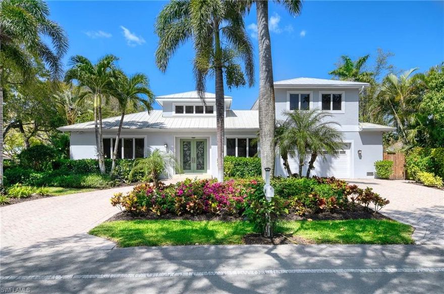 Built in 2012 and perfectly positioned in a coveted X500 flood zone, offering the peace of mind and exceptional appeal that come with its desirable elevated location, this home features three spacious bedrooms, including a first-floor primary suite and two private guest bedrooms on the second level. Thoughtfully designed and perfect for both daily living and entertaining with a versatile den on the main level for further flexibility as a home office, library, or creative space. Warm wood flooring flows seamlessly throughout, while tray ceilings with crown molding exude sophistication. The open-concept great room transitions effortlessly from the kitchen, which boasts stainless steel appliances, a central island with a breakfast bar, and generous storage perfect for casual dining or meal preparation. The first-floor primary suite is a private oasis, featuring a luxurious ensuite with a tub, walk-in shower, and dual sinks. Upstairs, the guest bedrooms are generously sized, offering comfort and privacy for family and friends. Outside is your private sanctuary, where a spacious covered lanai provides the perfect setting for tranquil evenings or lively gatherings. A sparkling pool, bathed in southern sunlight, is framed by a paver deck and lush, mature landscaping. With the beach just a short stroll away via 3rd Avenue North, you can enjoy breathtaking sunsets nightly. Practical features include a metal roof, a spacious garage, and a paver driveway, all adding to the home's curb appeal. Beyond the property, you’re moments from the best of Olde Naples.  World famous sugar-sand beaches, vibrant dining and shopping on 5th Avenue S, and nearby parks and cultural attractions. This home is more than just a residence, it’s a lifestyle. With its impeccable design, prime location, and array of comforts, this property offers a rare opportunity to experience the very best of coastal living.  A must see!