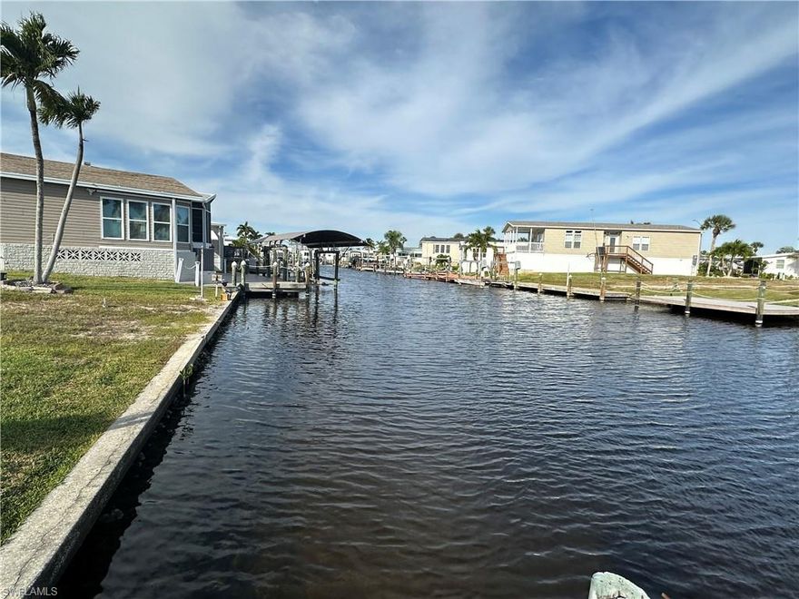 Bayside Estates has essentially two half’s, split down the middle by Stevens Blvd. There is the retention pond side and the saltwater side. Both have their benefits. This lot is located on the retention pond side so there is always plenty of water in the canals. Once on the other side of the boat lift, the waterway to Hurricane Bay, Hell Peckney Bay, the Gulf of Mexico and beyond is completely unobstructed. Go shopping and pick out the manufactured home of your liking and have it delivered to this lovely lot and begin partaking in the benefits of this highly desirable community. As you can see, this lot has thousands of dollars in custom paver work, making your new home shine brightly. When looking to buy a vacant lot in Bayside Estates, you might consider a lot that has a seawall that is in good condition and a lot that already has a boat dock and boat lift included. This is one such lot. The boat lift has the aluminum structure in place for a boat cover. Bayside Estates is the best kept secret of Fort Myers Beach. This incredibly active and friendly 55+ community is the crown jewel on the gulf coast. Bayside estates is only 2.5 miles to the beach and is accessible by either car or boat--right from either your driveway or private boat dock. A very popular activity is riding your electric bicycles to the beach for the day and visit the world-famous Jimmy Buffett’s Margaritaville. Just don't step on a pop-top!!. Nearly all of the major retail vendors are within a very short driving distance for ultimate convenience. For those who don’t know a lot about Bayside Estates, it is a very fun place to call home---some would even say it’s a mature person’s playground. Whether you want to play pickleball, tennis or bocce ball or hang out at the community pool, or simply cruise the hood in your golf cart, there is always something going on around here. People are friendly and you will be warmly welcomed.
