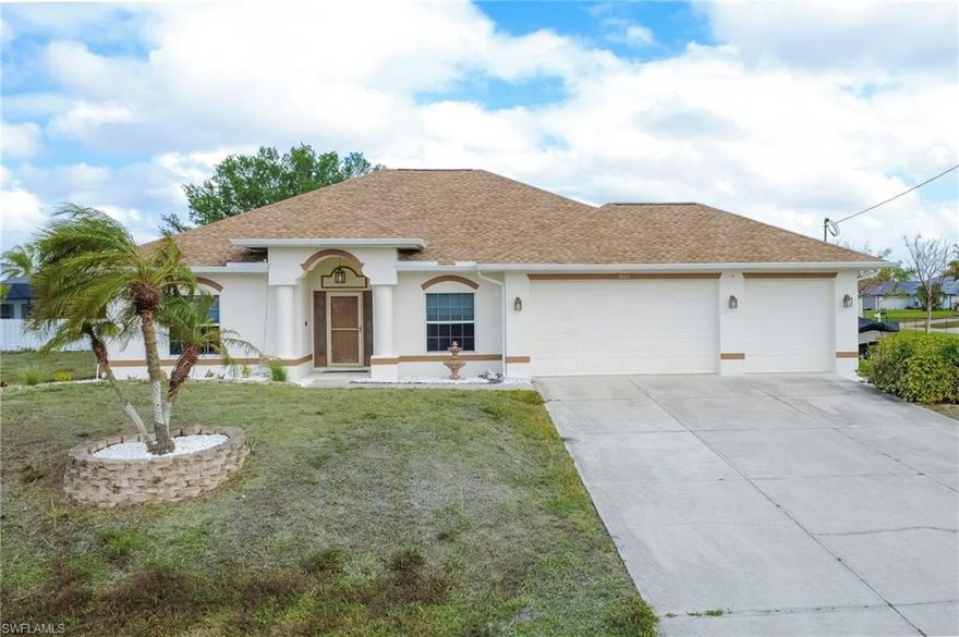Positioned as one of the lowest-priced 3-car garage pool homes in Cape Coral and located in an X flood zone, this impeccably maintained residence offers the ideal blend of relaxed Florida living and everyday functionality. Freshly repainted on the exterior, the home welcomes you with inviting curb appeal and a crisp, updated presence from the moment you arrive.

Step inside to a thoughtfully designed layout that balances openness with purpose—featuring a private den or home office to the left, perfect for working from home or unwinding with a good book, and a formal dining space to the right, ready for gatherings both intimate and festive.

At the heart of the home, the kitchen seamlessly connects to the main living area, creating a natural hub for conversation, cooking, and connection. With stainless steel appliances, generous counter space, and ample cabinetry, it’s designed for both everyday ease and effortless entertaining.

Expansive sliding glass doors draw your eyes outward to the pool and fenced backyard, filling the home with natural light and creating that sought-after indoor-outdoor flow that defines Southwest Florida living.

The split-bedroom floor plan offers a sense of privacy, with a spacious primary suite that feels like its own retreat—complete with dual vanities, abundant closet space, direct lanai access, and a newly updated walk-in shower with multiple shower heads for a spa-like experience at home. Guest bedrooms are comfortably sized and thoughtfully positioned, making hosting family and friends easy and inviting.

Out back, your private lanai and pool area set the stage for slow mornings, sunny afternoons, and evenings spent entertaining under the Florida sky. The fully fenced yard adds both privacy and flexibility for pets, play, or simply peace of mind.

Additional highlights include a 2023 roof, tile flooring throughout the main living areas, and new carpet in the bedrooms—ensuring comfort, style, and move-in-ready ease.