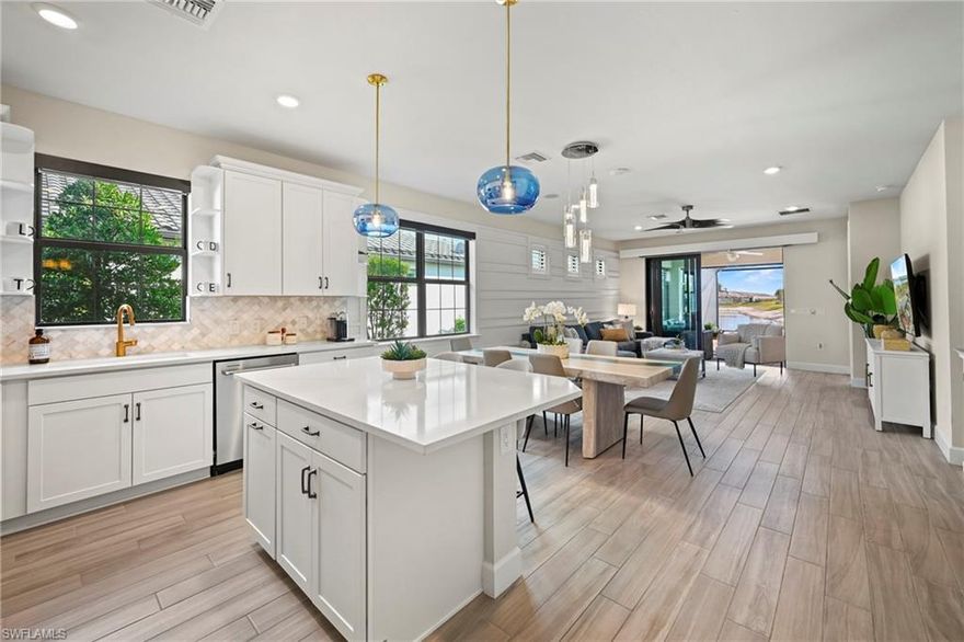 Live like you’re on vacation every day in this highly upgraded attached villa set inside one of SWFL's most desirable resort-style communities. From the moment you walk in, you’ll notice the designer feature walls in both the living room and primary suite, wood-look plank tile throughout (no carpet anywhere), custom closet organizers, and sleek electric shades on remote throughout the home. The kitchen is a showstopper with stainless appliances, statement lighting, and a layout made for entertaining.

Step outside to a sunny southern-exposure pool deck featuring a sun shelf and an extended in-water bench—perfect for relaxing and soaking up the Florida lifestyle. Hurricane shutters protect the lanai furniture, while impact windows, doors, and sliders add peace of mind. The den features custom barn doors and built-in storage, and all wall-mounted TVs stay.

The community delivers true resort living with a spectacular pool, the Bahama Bar and restaurant set on a peninsula surrounded by Lake Maggiore, plus tennis, pickleball, two dog parks, a playground, spa, and state-of-the-art fitness center—all just minutes to I-75, RSW, and Gulf Coast Town Center.
