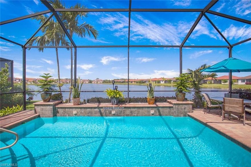 Welcome to Artesia, one of Naples' newest private gated lifestyle communities, offering an abundance of resort-like amenities with a low HOA fee. This pristine and expansive Nautilus model, built by renowned WCI, has two bedrooms, with an option for a third bedroom, and two full baths. Enjoy gorgeous long-lake waterfront views showcasing dramatic evening sunsets on Artesia’s second-largest lake. Relax all year round in the energy-efficient solar-heated swimming pool featuring a calming waterfall spillway and a convenient automatic pool vacuum. The home is beautifully decorated throughout and showcases an abundance of valuable upgrades, including impact-resistant windows, which provide the peace of mind of storm protection and a significantly quieter interior, as well as premium 42-inch kitchen cabinets, 10-foot-high ceilings, eight-foot-tall interior doors, upgraded crown molding, and upgraded baseboard molding, tile-to-ceiling shower enclosures, a five-panel high garage door, taller roofline, and Taexx tubes-in-the-wall built-in pest control system. Additional features include a stylish custom great room built-in with a modern electric fireplace, an expansive primary suite with dual walk-in closets, dual sink primary vanity, thick glass frameless Euro shower enclosure, double-thick Arabescato Bianco marble bath counters, new in 2023 high-end stainless steel GE Profile Smart appliances, a built-in wine refrigerator, upgraded multi-color controllable recessed LED and accent lighting, high-quality plantation shutters throughout, French doors to the den, ceiling fans, laundry room cabinetry, a convenient utility sink, lanai cabinetry with a refrigerator, Storm Smart hurricane screen on the lanai, pool cage, and screen-enclosed front porch, both with 20/20 no-see-um screens. Interior TVs excluded. Lanai TV included.