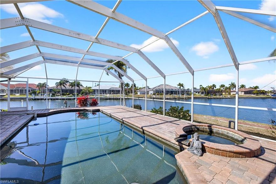 "SALT-LIFE" BOATING-FISHING-BEACHES-SUNSHINE! BURNT STORE ISLES-STUNNING $1,000,000 WIDE WATER VIEWS! UPDATED OVERSIZED TIP LOT (185') W/SPACIOUS 3 BEDROOM, PLUS OFFICE, 3 BATH, 2-CAR GARAGE WATERFRONT POOL HOME  WITH SAILBOAT ACCESS TO CHARLOTTE HARBOR AND OPEN WATER GULF FISHING! Nestled on a quiet cul-de-sac street with 185’ of water frontage, wide basin access and intersecting canal views. Big  DOUBLE-DOOR ENTRY, Open Floor Plan WITH OVER 2900 SQUARE FEET OF LIVING SPACE, 14' volume ceilings and tile floors through the halls, bathrooms and kitchen. Lots of HIGH GLASS WINDOWS AND SLIDERS, MAKES THE HOME LIGHT-BRIGHT-SUNNY ALL YEAR ROUND. "CHEF'S" Kitchen with all Stainless Steel high end appliances,  Corian Counter Tops, BREAKFAST BAR AND BREAKFAST AREA TABLE and Wood Cabinetry with lots of cabinet space and storage drawers.  The living room boasts a large pocketing slider to lanai with pool and water views plus formal dining area. The spacious family room offers access to the lanai, making it a perfect spot for entertaining. MASTER SUITE HAS 10' CEILINGS, HIS & HERS WALK-IN CLOSETS, DUAL SINKS & VANITIES, WALK-IN TILE & GLASS SHOWER, BIDET AND ROMAN SOAKING TUB. The split floor plan ensures privacy for all, with two guest bedrooms and a separate bath. INDOOR-OUTDOOR LIVING ARE A SPECIALTY HERE WITH BOTH COVERED PAVER LANAI & OPEN PAVER POOL DECK. POOL IS HEATED, OVERSIZED AND WITH AN ADDED SPA, YOU HAVE THE BEST OF BOTH WORLDS. Enjoy the convenience of an outdoor half bath and shower, along with a separate patio area ideal for grilling. Home has a private dock with lift—perfect for fishing or simply enjoying a "evening cocktail" on the water. Located in a popular deed-restricted TWIN ISLES GOLF & COUNTRY CLUB, which offers it's residents OPTIONAL ARRAY OF MEMBERSHIPS FROM SOCIAL TO GOLF. Members  can enjoy an 18-HOLE CHAMPIONSHIP GOLF, swimming pool, tennis complex, and a spacious clubhouse with FINE DINING & CASUAL dining and many planned social events. Easy to I-75 and minutes to all major shopping, restaurants, schools, churches a short drive to the Yacht Club, Fisherman's Village, and HISTORIC OLD PUNTA GORDA . HOME COMES WITH ONE YEAR "HOME WARRANTY" FOR TOTAL BUYER COMFORT!
