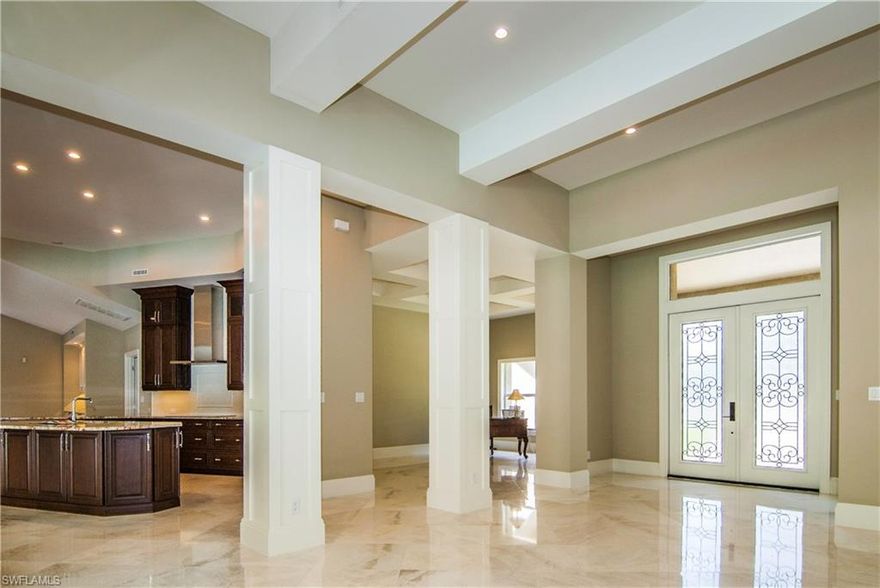 Welcome to Pelican Bay at its finest! This custom home is situated in the heart of Pelican Bay and was completely remodeled by award winning builder Ryan Contracting, Inc. and designed by Pamela Durkin Designs, LLC. Features include stunning marble floors, coffered ceilings, a tastefully updated and expanded kitchen with custom cabinetry, Bosch appliances, an induction cook-top, and a fireplace that brings warm ambiance to it's spectacular great room. The new pool area is equipped with a therapeutic jet system and beautiful landscaping, adding privacy and outdoor charm to this spectacular home. Located on one of the more desirable large lots in Pelican Bay, almost 1/2 acre, the buyers will certainly be happy when they receive a $50,000 credit at closing for their own finishing touches.