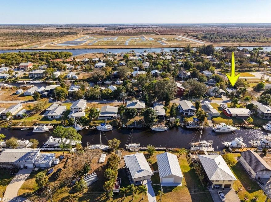 Enjoy true waterfront living on a deep-water canal with direct dockage for your boat. This 2-bedroom, 1-bath mobile home offers comfortable interior space paired with exceptional boating access. Two docks provide flexibility — one accommodates a sailboat, while the second offers additional docking potential (in need of repair).

Inside, the home features a functional kitchen with gas stove, built-in microwave, double-door refrigerator, deep double-bowl sink with modern spray faucet, attractive backsplash, built-in pantry with sliding doors, wood cabinetry, deep cabinet drawers, and a custom buffet with wall-mounted bookshelves. Accent lighting and an open pass-through connect the kitchen to the spacious enclosed Florida room.

The Florida room includes two ceiling fans and French doors that open to a patio overlooking the canal and boat dock. The outdoor patio is enhanced with sun sails for shaded relaxation, creating an ideal setting to enjoy the waterfront lifestyle. A single exterior door provides convenient access to the laundry/workshop shed.

Additional highlights include central air conditioning and a screened front porch with roll-down curtains and decorative chandelier.

This property offers affordable canal-front living with both indoor comfort and the outdoor access boating enthusiasts seek.