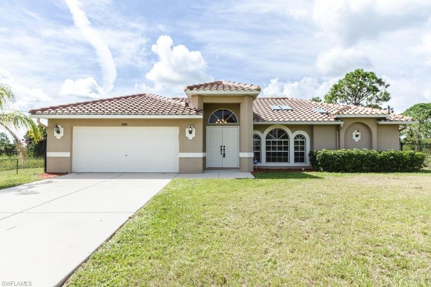 2.27 acres which has been mostly cleared, a great fenced-in area for your pets, and close to the new shopping area and local schools. No waiting for new constructions! Excellent Estates home!  This 3 bedroom home offers a split bedroom floor plan, a great open concept with beautiful laminate floors throughout most of the home.  Many special details including crown molding everywhere, skylights with blinds (the blinds and skylights all open) in the Kitchen, Living Room and Master Bathroom, and special details throughout the home.  The 2nd Bathroom shower is new as is the sink and vanity unit in the Master Bathroom.  Wonderful kitchen with pantry, raised-panel cabinets, breakfast bar and crown molding. The Master Bedroom has sliding doors that open to the screened in lanai and is a spacious retreat with crown molding and lovely bathroom.  This terrific, partially furnished (optional) home is ready for you to move straight into and has plenty of room to add a pool if so desired.