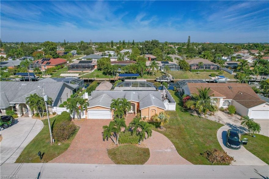 This Gulf Access Pool Home is centrally located in SE Cape Coral with its own Private Tiki Hut & outdoor kitchen!!  
Tile floors throughout, Granite countertops, Wood cabinets, & top of the line SS Appliances in the kitchen. The sqft was maximized by enclosing the outside overhang & converting half of it into an office with incredible water views! The backyard is fully fenced in, with different fruit trees like Mango & Avocado. The home features Hurricane Impact resistant windows, updated bathrooms, huge circular paved driveway, the A/C was recently replaced, captains dock & boat lift! This house is loaded!! Schedule a private showing today!