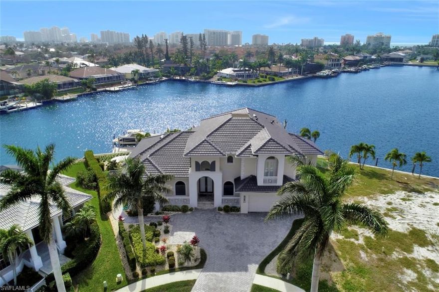 A Breathtaking home with breathtaking views!! This home has it all! Highly sought after Southwest Rear Exposure! Built in 2014 with no expenses spared! Professionally furnished and decorated. 4 Bedrooms + Study, 4 1/2 Baths, with additional upstairs sitting area. This home is beautifully designed on a TIP lot with a 169 feet of water frontage overlooking huge water views of Landmark Bay and the Marco Beachfront Skyline!! Massive outdoor covered living area with electric roll down screens!! Enjoy fishing, boating, waverunners, kayaks, and paddleboards right from your own backyard.