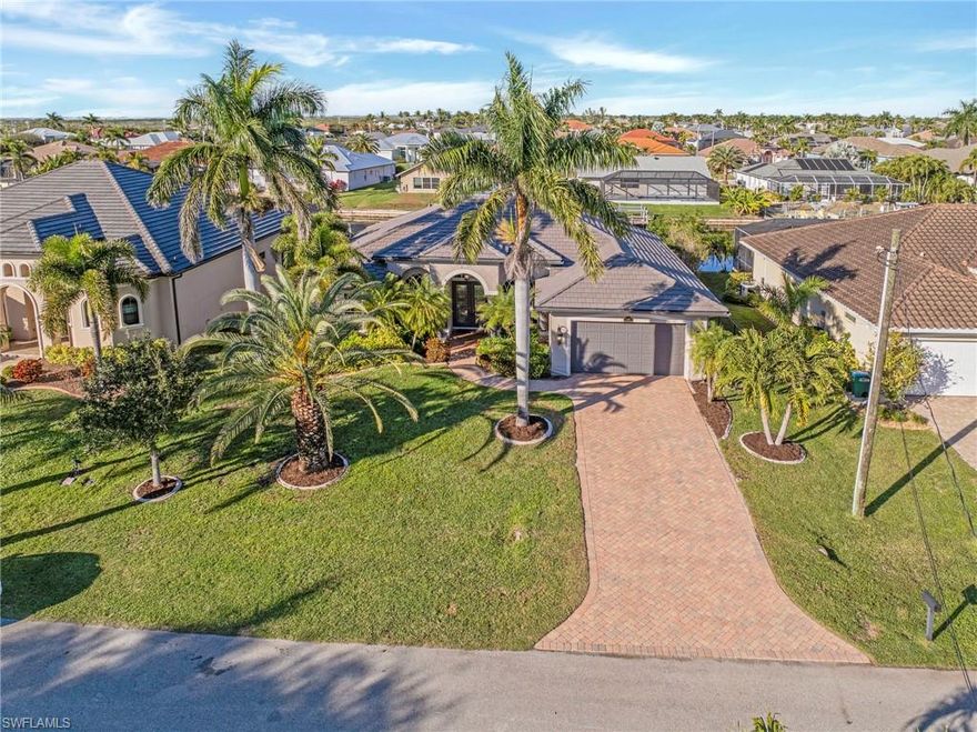This beautifully maintained Cape Coral residence offers the ideal blend of comfort, style and Florida lifestyle appeal in a highly desirable southwest location. Thoughtfully designed with an open and inviting layout, the home features spacious living areas filled with natural light, creating a warm and welcoming atmosphere from the moment you enter. The kitchen is well-appointed and positioned to serve as the heart of the home, seamlessly connecting to dining and living spaces that are perfect for everyday living and entertaining alike. Generously sized bedrooms provide comfort and privacy, while the primary suite serves as a peaceful retreat with ample closet space and a well-designed bath. Additional peace of mind is provided by a full house Generac generator, ensuring reliable power and uninterrupted comfort year-round. Outdoors, the home truly shines with a private pool and spa, complemented by a 10,000-lb boat dock, offering effortless access to the waterways and an exceptional boating lifestyle. Step outside to enjoy a serene outdoor setting that captures the essence of Southwest Florida living, ideal for relaxing evenings and entertaining guests. The property is situated in an established neighborhood known for pride of ownership, with convenient access to waterfront dining, shopping, parks, marinas and top-rated schools. Whether you are seeking a full-time residence or a smart long-term investment, this home delivers timeless appeal, functionality and the opportunity to enjoy the laid-back yet refined lifestyle Cape Coral is known for.