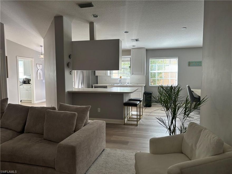 furnished and move-in ready, this elegant 2-bedroom + open den, 2-bath villa in the highly desirable, gated community of Island Walk in Naples invites you to experience refined, resort-style flair. Thoughtfully designed with soaring ceilings, abundant natural light, and a seamless open-concept layout, the home features a timeless white island kitchen that connects effortlessly to the main living and dining areas—perfect for both everyday comfort and easy entertaining. The owner’s suite is a peaceful retreat with two spacious closets and a spa-like ensuite bath featuring a dual vanity and walk-in shower. A split-bedroom design ensures privacy, while the open den area provides a flexible space for reading, relaxing, or casual work. An oversized laundry room with generous cabinetry and counter space enhances daily functionality with style. Step outside to a beautifully landscaped backyard with wide, open views—ideal for morning coffee, evening breezes, or dining al fresco. Beyond the home, Island Walk offers an exceptional lifestyle defined by scenic Venetian-style bridges, peaceful waterways, and an impressive lineup of amenities including a resort-style pool, state-of-the-art fitness center, tennis and pickleball courts, on-site dining, a salon, post office, and even a gas station. With a full-time activities director and countless opportunities for connection, recreation, and relaxation, Island Walk blends vibrant community living with everyday convenience. All this, just minutes from Naples' world-renowned beaches, golf, dining, and shopping, makes this furnished villa a rare opportunity to enjoy the very best of Southwest Florida