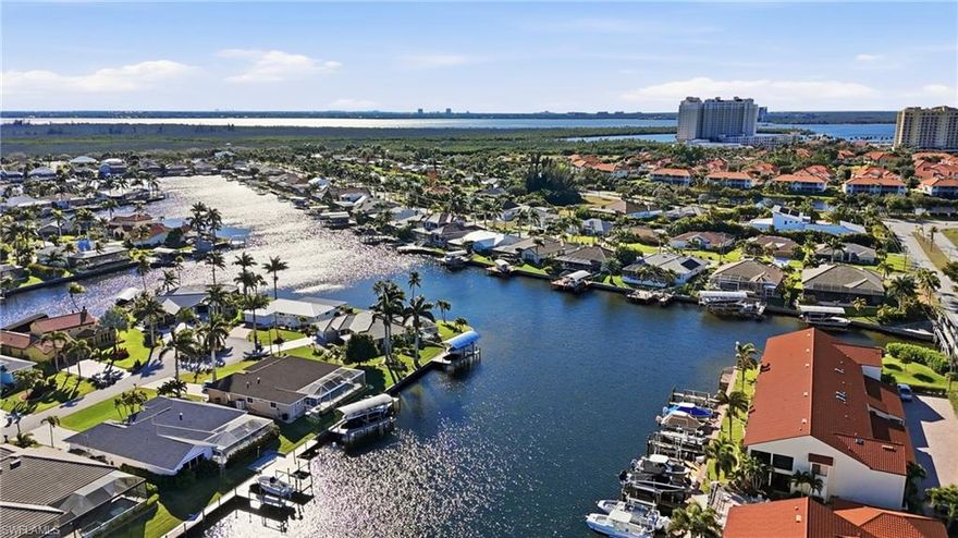 Boaters welcome to a fully remodeled Gulf access waterfront condo with private dock, boat lift, and an attached 1 car garage in the highly desirable Capstan II community of Southwest Cape Coral. This rare offering lives like a home without the maintenance and offers a price point you will not find for a waterfront home near Tarpon Point Marina and The Westin Cape Coral Resort. This spacious 3 bedroom, 2 full bathroom residence features over 1,562 square feet of living area and has been completely renovated from top to bottom. Interior upgrades include large-format tile flooring throughout with no carpet, fresh paint, new baseboards, new doors, updated HVAC system, a modern kitchen with quartz countertops, soft-close cabinetry, stainless steel appliances, pendant lighting, and new vanities. The result is a clean, contemporary coastal design that is truly move-in ready. The open living area flows seamlessly to your private screened lanai with matching tile and desirable southern exposure, perfect for sunbathing, relaxing, and watching boats pass by on the wide Gulf access canal. Your assigned dock and boat slip with lift are just steps from your back door, offering quick access to open water and making this an ideal full-time residence, second home, or seasonal retreat for boating enthusiasts. This unit also includes a private one-car attached garage with additional storage. The Capstan II community is meticulously maintained and features a heated pool and clubhouse, all set within one of the most sought-after neighborhoods in Southwest Cape Coral. Located in the prestigious Rose Garden area, you are minutes from Tarpon Point Marina, the Westin Resort and Spa, waterfront shopping, dining, live music, and events. Enjoy nearby favorites such as Gather, High Tide Social House, Pinchers, The Nauti Mermaid Bar and Grill, and Marker 92. Golfers will appreciate proximity to Palmetto Pines Country Club and Coral Oaks Golf Course. The Yacht Club Beach and Marina, Bimini Square, The Cove, and Slipaway are all close by, placing you at the center of Cape Coral’s premier waterfront lifestyle. The canal is approximately 200 feet wide, offering expansive big-water views and long sight lines down the waterway, creating a sense of openness rarely found in condo living. Major exterior improvements include a new roof, fresh exterior paint, updated landscaping, and a new dock currently being installed. Future development in the area, such as the Cape Coral Grove mixed-use town center and the Seven Islands Project, will further enhance property values and lifestyle amenities with additional marinas, restaurants, boutique shopping, parks, and community events. OWNER FINANCING AVAILABLE. This Gulf access condo offers 3 bedrooms, 2 bathrooms, a private garage, a boat dock, and a lift in a prime Southwest Cape Coral location.