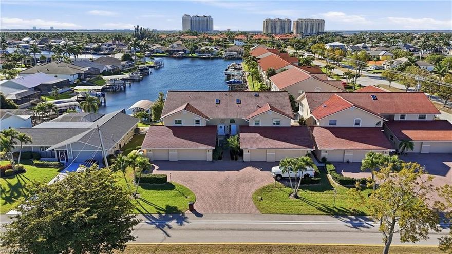 Boaters welcome to a fully remodeled Gulf access waterfront condo with private dock, boat lift, and an attached 1 car garage in the highly desirable Capstan II community of Southwest Cape Coral. This rare offering lives like a home without the maintenance and offers a price point you will not find for a waterfront home near Tarpon Point Marina and The Westin Cape Coral Resort. This spacious 3 bedroom, 2 full bathroom residence features over 1,562 square feet of living area and has been completely renovated from top to bottom. Interior upgrades include large-format tile flooring throughout with no carpet, fresh paint, new baseboards, new doors, updated HVAC system, a modern kitchen with quartz countertops, soft-close cabinetry, stainless steel appliances, pendant lighting, and new vanities. The result is a clean, contemporary coastal design that is truly move-in ready. The open living area flows seamlessly to your private screened lanai with matching tile and desirable southern exposure, perfect for sunbathing, relaxing, and watching boats pass by on the wide Gulf access canal. Your assigned dock and boat slip with lift are just steps from your back door, offering quick access to open water and making this an ideal full-time residence, second home, or seasonal retreat for boating enthusiasts. This unit also includes a private one-car attached garage with additional storage. The Capstan II community is meticulously maintained and features a heated pool and clubhouse, all set within one of the most sought-after neighborhoods in Southwest Cape Coral. Located in the prestigious Rose Garden area, you are minutes from Tarpon Point Marina, the Westin Resort and Spa, waterfront shopping, dining, live music, and events. Enjoy nearby favorites such as Gather, High Tide Social House, Pinchers, The Nauti Mermaid Bar and Grill, and Marker 92. Golfers will appreciate proximity to Palmetto Pines Country Club and Coral Oaks Golf Course. The Yacht Club Beach and Marina, Bimini Square, The Cove, and Slipaway are all close by, placing you at the center of Cape Coral’s premier waterfront lifestyle. The canal is approximately 200 feet wide, offering expansive big-water views and long sight lines down the waterway, creating a sense of openness rarely found in condo living. Major exterior improvements include a new roof, fresh exterior paint, updated landscaping, and a new dock currently being installed. Future development in the area, such as the Cape Coral Grove mixed-use town center and the Seven Islands Project, will further enhance property values and lifestyle amenities with additional marinas, restaurants, boutique shopping, parks, and community events. OWNER FINANCING AVAILABLE. This Gulf access condo offers 3 bedrooms, 2 bathrooms, a private garage, a boat dock, and a lift in a prime Southwest Cape Coral location.