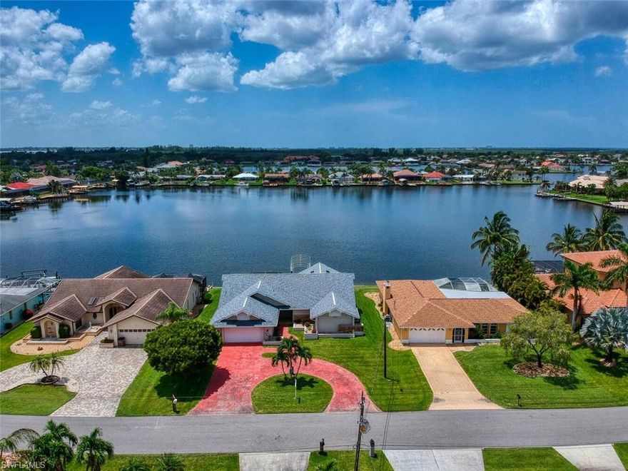 Prestigious Eight Lakes area of Cape Coral. This three-bedroom, two-and-a-half-bathroom plus den/office pool home features a 10,000-pound covered boat life (SOUTHERN EXPOSURE), a new roof-February 2021, ALL SIX SKYLIGHTS WERE REPLACE (NEW) WHEN THE ROOF WAS REPLACED. Two-zone HVAC (installed in 2021 and 2014). ALL windows and doors have hurricane protection. Also, an eat-in kitchen formal dining room, and a huge living room with vaulted ceilings. You can see the lake from the living room, dining room, kitchen, and master bedroom!
Two separate security systems, one is wireless and monitored by an alarm company the other is interior and exterior cameras.