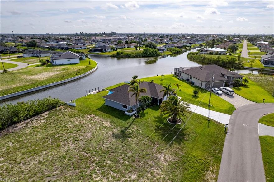 Build your dream waterfront home on this stunning lot with intersecting canal views and access to lakes and basin areas. Kayak or fish right from your backyard and enjoy peaceful water views every day. Located on a quiet freshwater canal in a highly desirable Cape Coral neighborhood, this rare property offers both serenity and convenience. NO flood insurance required—and offers city water and sewer with assessments almost paid in full.  Set in a well-established area near the rapidly growing Pine Island Corridor, you’ll enjoy easy access to shopping, dining, and major roadways. A perfect opportunity to create your ideal Florida retreat or invest in a prime location.