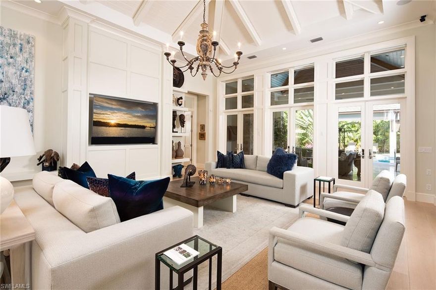 In a coveted west of Crayton Road location, this Moorings home was designed by Falcon Design and built by the Knauf-Koenig Group, LLC. Just minutes to the private Moorings Beach, this 4,346 square foot home has been masterfully designed with beautiful architectural details throughout. The open concept floor plan has tall transom windows in the great room, wide plank flooring, and extensive custom wood trimmed details. A fully-appointed gourmet kitchen includes Sub-Zero and Wolf appliances, custom cabinetry, quartz countertops, wine storage and beautiful wet bar. This 5-bedroom, 5 full and 2 half baths residence has a stunning master suite and 4 luxurious guest suites for family and friends. This home boasts a gorgeous tropical outdoor space designed for effortless entertaining with summer kitchen, gas fireplace, and large screen TV. The pool deck surrounds a beautiful pool and spa with stepping stones and sun shelf. For further relaxation, a spacious covered gazebo adds to the resort style ambiance. Lush landscaping exudes privacy and tranquility. Additional features include a detached home gym, 32Kw Generator, security system, remote control screens and shutters and more!