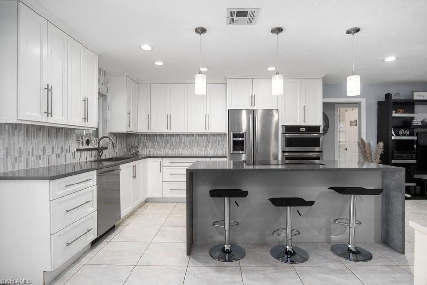 This INCREDIBLE centrally located Willoughby Acres 3-bedroom, 3 bath pool home with an upgraded custom dream kitchen, stainless steel appliances, quartz countertops, soft-close custom kitchen cabinets. All the bathrooms have been completely remodeled with designer tile, custom cabinetry, upgraded vanities. In addition to the three Bedrooms and three Bathrooms, there's an Office/Den that allows you to work right from home and close enough to jump right into your stunning Pool with a screened Lanai which features an amazing built-in tiki. This home had a New Roof in installed in 2016, impact windows. Fenced in back yard with plenty of shade will allow you to Enjoy this home with NO HOA fees. Approximately 4 miles to the beach, and in close proximity to shopping and dining make this home a MUST SEE!