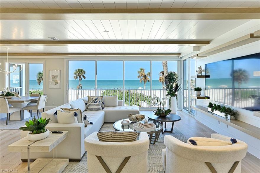 This Villas at Barefoot Beach 3 story beachfront home has been renovated throughout with a completely reimagined open floor plan & finished to the same or higher level as the $10-$20+ million dollar homes immediately to the south. As you enter the main living level there are wide left to right panoramic views of the Gulf of America through a wall of floor to ceiling sliding glass doors & a massive window in the dining room for sunsets. The great room was enlarged & structural changes provided for no columns in the main floor great room, kitchen & dining room. The kitchen has custom cabinetry to the ceiling, large sit at island for 4, Monogram refrigerator, induction smart range built in wine/ beverage refrigerator, designer quartz countertops & backslash.  The dining room w/ bench wall has seating for 8, & the full wall mirror offers views of the turquoise water from every seat. The great room features a large screen TV, shiplap wall with custom shelves then blends seamlessly with the ship lap ceilings & wood beams. A walk behind sit at bar with a wall mirror the reflects the Gulf waters. There is a guest bedroom on the main living level with custom designed bed wall a beautifully finished private bathroom. The walk-in laundry room & Powder bath complete the main living level.  The 3rd level includes a large master suite with millwork details, wide Gulf views, open private sun deck plus the ultimate master bath with oversized vanities, tile & mirror wall, tub is in the giant shower & 2 closets. The beach front guest bedroom has a wall of glass & en-suite bath, detailed millwork wall. Bedroom 4 also features a custom wood bed wall & amazing en suite bath. For convenience there is a second laundry & office work desk. The den is currently set up as a 5th bedroom. The lower level features a two car garage, lower foyer & outdoor covered deck.  The designer furnishings package can be purchased at actual cost - no design fee. The Villa has wide plank oak wood flooring throughout, tile flooring & walls taken to a new level in all bathrooms, electric window blinds, window treatments& designer light fixtures. New items include staircase & railings, electrical,  plumbing including fixtures, air conditioning, hot water heater, metal roof & impact sliders/windows. Windows on east side have electric shutters. Villas at Barefoot Beach amenities include gated entrance with 24 hour guard patrols, 2 swimming pools & one spa, private beach walkway with sunset deck & option to lease a boat dock across the street within the community - separate lease. Option to join the Club at Barefoot Beach (located in the community) which offers casual & fine dining restaurants, pool & beachside food, drinks, chair service, indoor & outdoor bars, ice cream & coffee shop, tennis courts with pro & a full events calendar. (waitlist with usage during wait period). Barefoot Beach In Collier County is centrally located to dining, entertainment, golfing & arenas. HOA - you own the land!