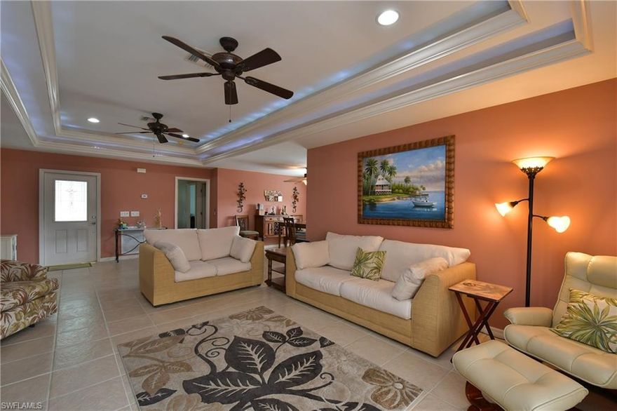 JUST LISTED. 2007 concrete block construction with new stone accents enhancing the front elevation. 3 bedrooms, 2 baths, and detached 2 car garage with covered gated entryway. Open floor plan with tray ceilings and plantation shutters. Tile flooring throughout including lanai. Granite kitchen counters with rich cherry wood cabinetry. French doors lead from great room to new oversized screened lanai with completely fenced back yard. Private front courtyard with built-in grill for enhanced outdoor entertaining. Circular driveway provides ample guest parking. Adjacent lot available exclusively to successful buyer (if desired) at additional cost.