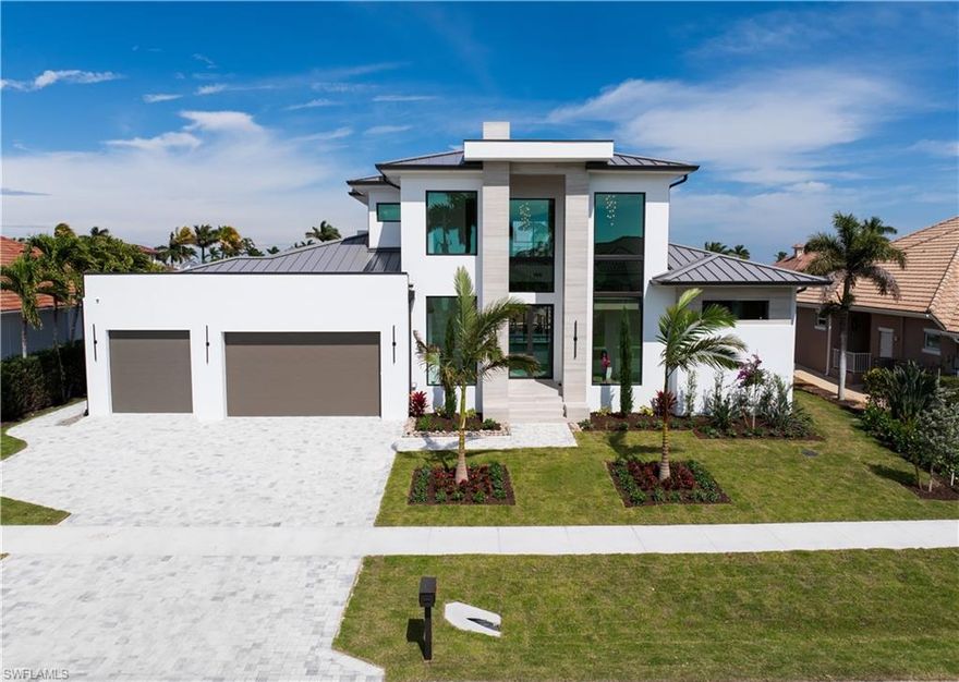 Welcome to 159 Dan River Ct — a striking contemporary new construction waterfront estate on Marco Island, offering 4,345 sqft under air, 5 ensuite bedrooms, 5.5 baths. Impeccable craftsmanship throughout built by Werning Construction. This architectural showpiece combines sleek modern design with effortless coastal sophistication. Step through the grand entry to soaring ceilings, floor-to-ceiling glass, and an open-concept layout that invites in natural light and showcases panoramic canal views. The gourmet kitchen is a true centerpiece — featuring top-of-the-line Wolf appliances, Sub-Zero refrigeration, custom cabinetry, quartz countertops, and an oversized island designed for gathering and entertaining. Each bedroom serves as a private retreat, complete with its own ensuite bath and designer finishes. The luxe primary suite offers tranquil water views, a spa-inspired bathroom, and direct access to the lanai. Thoughtfully designed for both comfort and convenience, the home includes a 3-stop elevator, laundry rooms on both the main and upper levels, and smart integrations throughout — ideal for families or guests. Experience true indoor-outdoor living with a resort-style pool, integrated spa, outdoor kitchen, motorized bug screens, and shutters, along with a spacious covered lanai — perfect for sunset dining or lounging in the Florida breeze. With direct Gulf access to the river this home is ideal for boating enthusiasts and fisherman both. Additional highlights include hurricane-impact glass, a whole house generator, a 3-car AC garage, and a prime location just minutes from world-class beaches, shopping, and dining. Don't miss your chance to own a modern waterfront masterpiece in paradise.