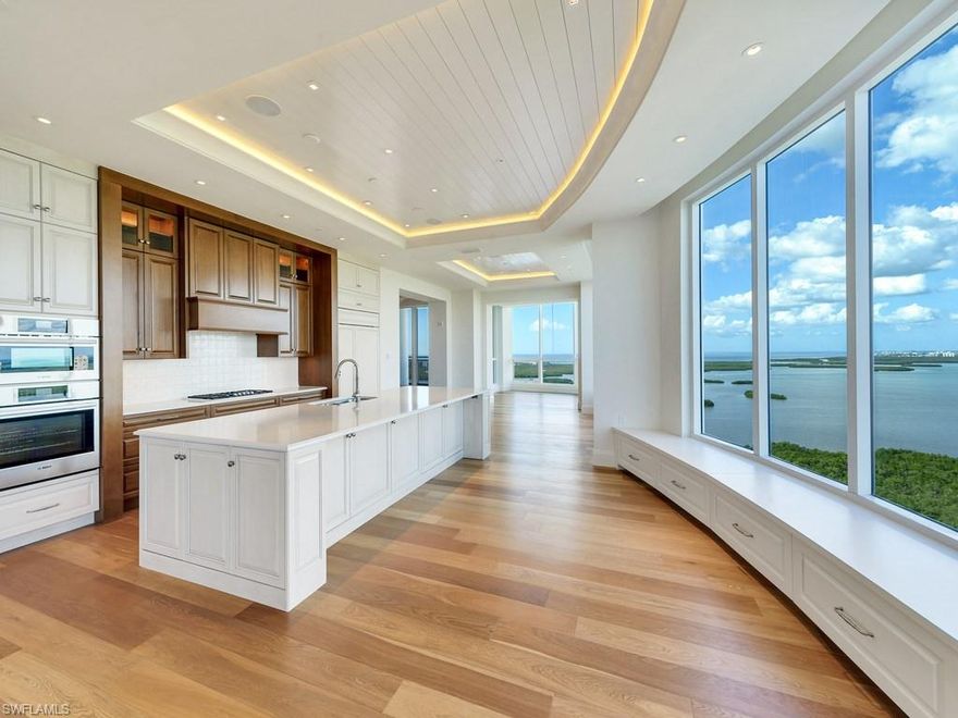 C.298 - This one-of-a-kind magnificent Penthouse in Seaglass, the newest high-rise in Bonita Bay, has been built-out by Ramonza Interiors to create a comfortable and luxurious living environment. Never lived-in and ready for you to add your own distinctive final touches! The spacious three bedroom plus study, and library/media room, lives like a single family home, providing privacy to guests and owners. The kitchen and family room serves as the perfect place for family and friends to gather to enjoy the captivating sunsets and uninterrupted long water views of the Estero Bay and the Gulf of Mexico. The well appointed kitchen includes a 48” Sub-Zero refrigerator, Bosch oven, 2 dishwashers, Thermidor gas stove top, a large quartz eat-in kitchen counter and soft touch cabinetry. Enjoy grilling on the gas grill located in the screened west facing terrace. Lutron lighting system and Audio/Visual/Wireless Network, Built-in cabinets & wet bar in family room with Sub-Zero wine cooler, built-in Media room that is prewired for drop down screen projector, 11 ft ceilings that allow for fabulous ceiling treatments, to mention only a few.  Also includes a private enclosed 2 car garage.