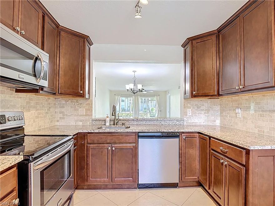 Welcome to Newcastle at the renowned Berkshire Lakes, in the heart of Naples! This inviting 2-bedroom, 2-bathroom condo offers 1,300 square feet of comfortable living space, perfectly designed for modern convenience and leisure. Step inside to find a bright and spacious first-floor unit adorned with elegant tile floors in the living areas and newly added quality laminate floors in the bedrooms. The eat-in kitchen features sleek stainless steel appliances, granite countertops, and custom wood cabinetry, making meal preparation and entertaining a delight. The bathrooms have been fully renovated, featuring granite countertops and a luxurious glass shower in the master bathroom, adding a touch of elegance and modernity to your daily routine. Relax on the screened lanai with expansive green space views, providing unparalleled privacy, or take a dip in the community pool. This home is fully hurricane-proof, boasting shutters throughout and a large electric shutter on the lanai, ensuring peace of mind during stormy weather. Recently repiped with PEX piping and a new A/C unit, this condo is move-in ready and low-maintenance. Berkshire Lakes offers a wealth of amenities, including tennis, plus pickleball courts and common outdoor spaces, including a fishing pier, ideal for socializing or unwinding. With guest parking and a designated owner spot right at your doorstep, convenience is paramount. Located near pristine beaches, vibrant shopping, exquisite dining options, and more, this property is not only an idyllic seasonal home but also an attractive investment opportunity for rental income. Additionally, the unit is also available for rent, annual minimum with immediate occupancy at a rate of $2,200/month. Experience the allure of Naples living in this charming community today!