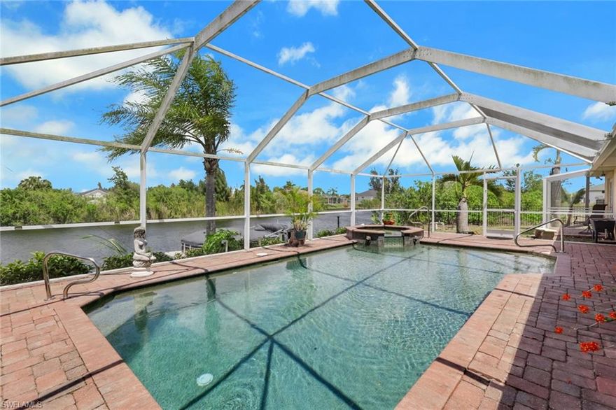 Exceptional opportunity to own a beautifully updated waterfront heated pool home in NW Cape Coral, featuring a desirable wider canal view of the Hermosa Canal.

The exterior welcomes you with a double-door entry, mature tropical landscaping including banana trees, a fenced backyard, and a concrete cantilever dock—perfect for boating, fishing, or simply enjoying Florida’s natural beauty.

Outdoor living is designed for entertaining, offering a spacious covered lanai, heated pool, and an integrated spa that flows seamlessly into the pool. A brand-new metal roof (2025) and hurricane impact windows provide added peace of mind.

Inside, the remodeled chef’s kitchen is sure to impress with granite countertops, a large island with additional storage, upgraded white cabinetry with crown molding and modern hardware, soft-close drawers and cabinets, a pot filler faucet, stainless steel appliances, a cabinet pantry, new tile flooring, and a full exhaust system—ideal for both everyday living and entertaining.

The split floor plan features a spacious primary suite complete with a large walk-in closet, soaking tub, walk-in shower, and French doors leading to the oversized under-truss lanai and pool area. The guest suite offers its own private screened lanai—perfect for enjoying a quiet morning coffee or relaxing in privacy. The guest pool bath includes a tiled shower with frameless glass doors.

Waterfront + heated pool + spa + wider canal + no flood insurance—this is a rare find in today’s market!