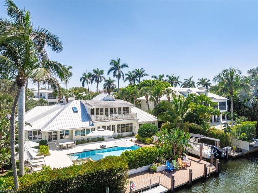 Welcome to your dream home in prestigious Aqualane Shores, where waterfront living meets luxurious design! This quaint cottage has been masterfully recrafted on a premium lot, boasting a custom dock and boat lift with a grandfathered cut out, ensuring unparalleled direct gulf access without any bridges. Inside, you'll discover a breathtaking coastal interior featuring custom floors and exquisite craftsman millwork. The updated gourmet kitchen and fully renovated bathrooms elevate this home to modern standards of comfort and style. The thoughtfully designed floor plan offers a graceful flow between indoor living spaces and the serene outdoor oasis, ideal for relaxation and entertainment. Accommodating two master suites, this home provides versatility and privacy, with one suite located on the first floor and another on the second. An office area with stunning views overlooks the pool and water, perfect for work or leisure. The exterior boasts concrete siding and a newer metal roof, adding durability and charm. Strategically located just minutes from the vibrant downtown 5th Avenue South and 3rd Street South, you'll enjoy access to world-class dining, shopping, entertainment, and the mesmerizing White Sands Beaches. This efficient and expertly designed waterfront home offers an extraordinary lifestyle in one of Naples' most sought-after communities. Don't miss the chance to call this Aqualane Shores gem your own!