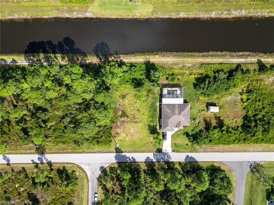Vacant lot in Lehigh Acres is now available and ready to build your dream home! The home backs up to a canal.
