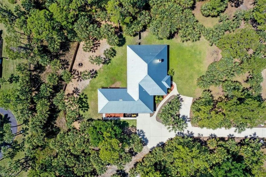 MUST WATCH OUR LIVE VIDEO TOUR! A stunning 4-bedroom + den dream home w/private guest suite & Guesthouse situated on a private park-like 2.65-acre lot makes for a livable paradise in a covetable location! Majestic mature trees w/deep driveway and attractive curb appeal just minutes to the beach & only 1mile to I-75. Light-filled, immaculately kept & offering quality single story living w/soaring 10' ceilings, this home is a must-see! This home reveals a timeless open concept layout that highlights a spacious custom kitchen complete w/stainless appliances & granite counters. The inviting living room is warmed by a floor-to-ceiling woodburning fireplace & double glass patio doors to the screened lanai that overlooks the scenic views of the fenced backyard. Freshly painted throughout, this exceptional home offers a guest suite accessed from the large screened lanai, plus a private 1BD/1BA mother-in-law suite w/a full kitchen & private entrance.